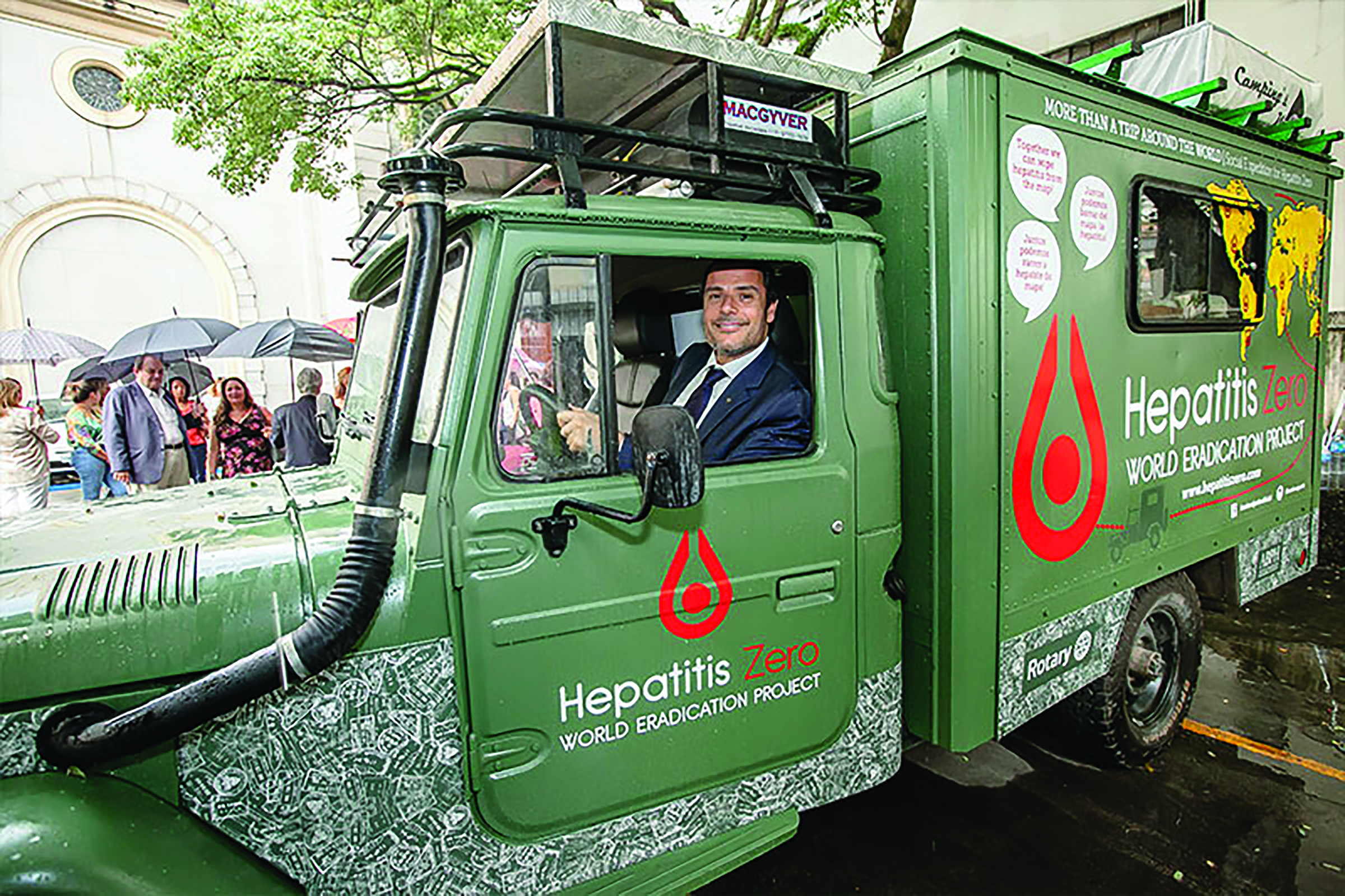 Humberto Silva behind the wheel of a converted military ambulance in which two brothers, Fred Mesquita and José Eduardo, are traveling the world educating people about hepatitis.