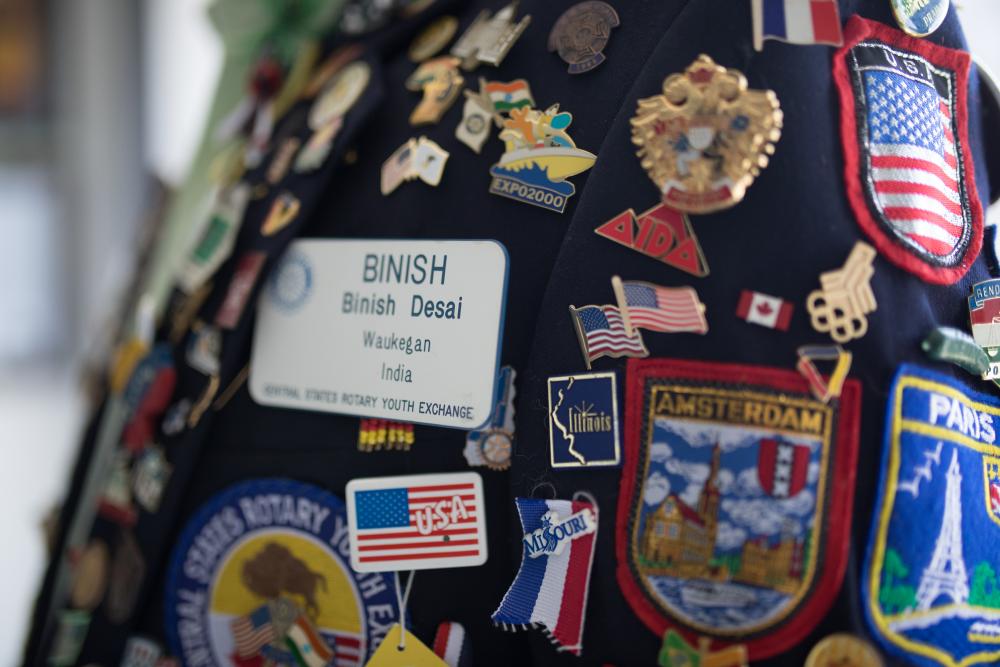 Desai's collection of badges on blazer