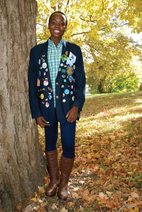 In her senior class photo, Wanzita Ally’s jacket features a wide array of buttons and pins and a Rotary patch on the pocket.